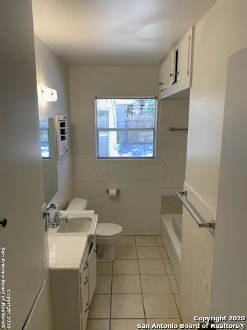 a bathroom with a sink toilet and tub