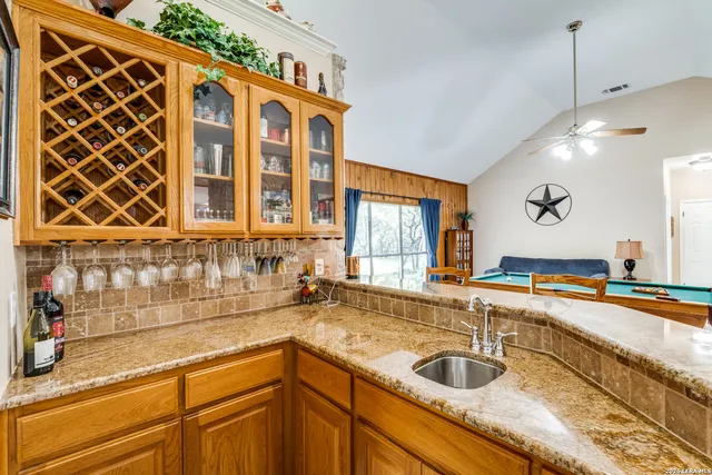 a bedroom with a bed a mirror and a window