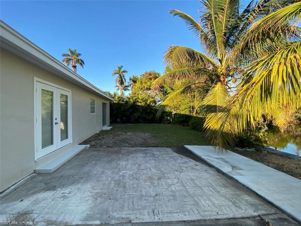 550 14th Street North Naples, FL 34102 - Photo 17 of 21 a view of a house with a yard