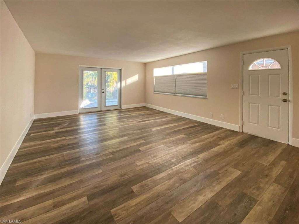 550 14th Street North Naples, FL 34102 - Photo 6 of 21 an empty room with wooden floor and windows