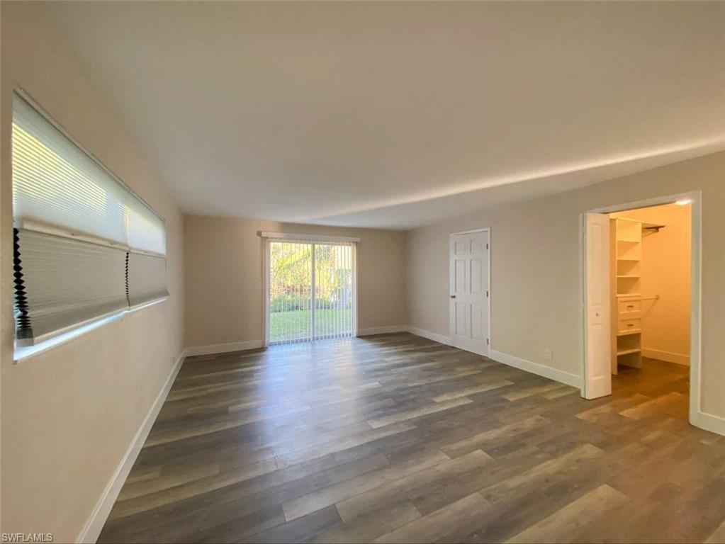 550 14th Street North Naples, FL 34102 - Photo 8 of 21 a view of an empty room with wooden floor and a window