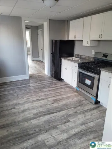 a kitchen with a sink and a stove top oven