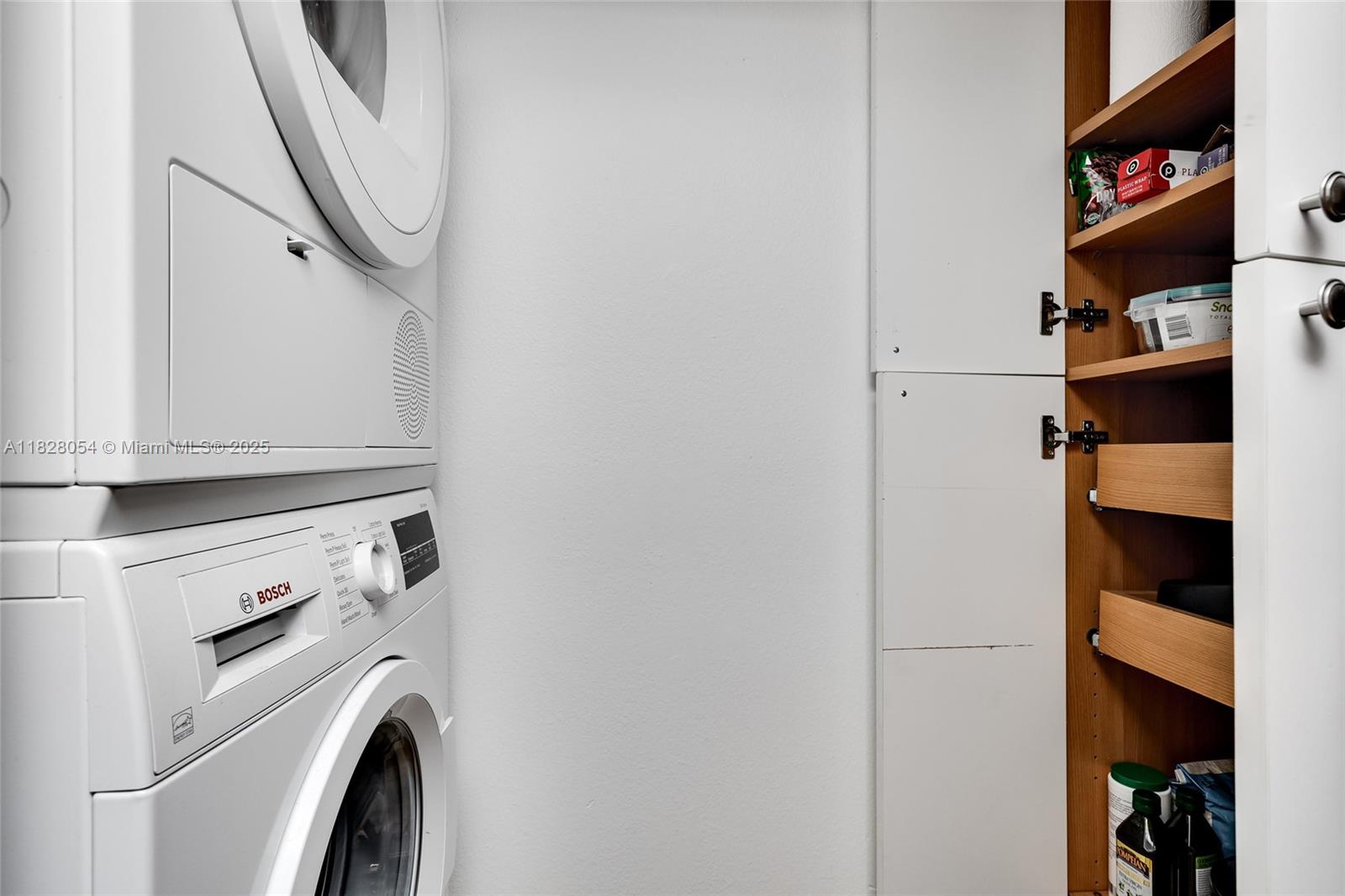 520 Brickell Key Drive, Unit A1817 Miami, FL 33131 - Photo 13 of 20 a view of walk in closet with clothes and shoes
