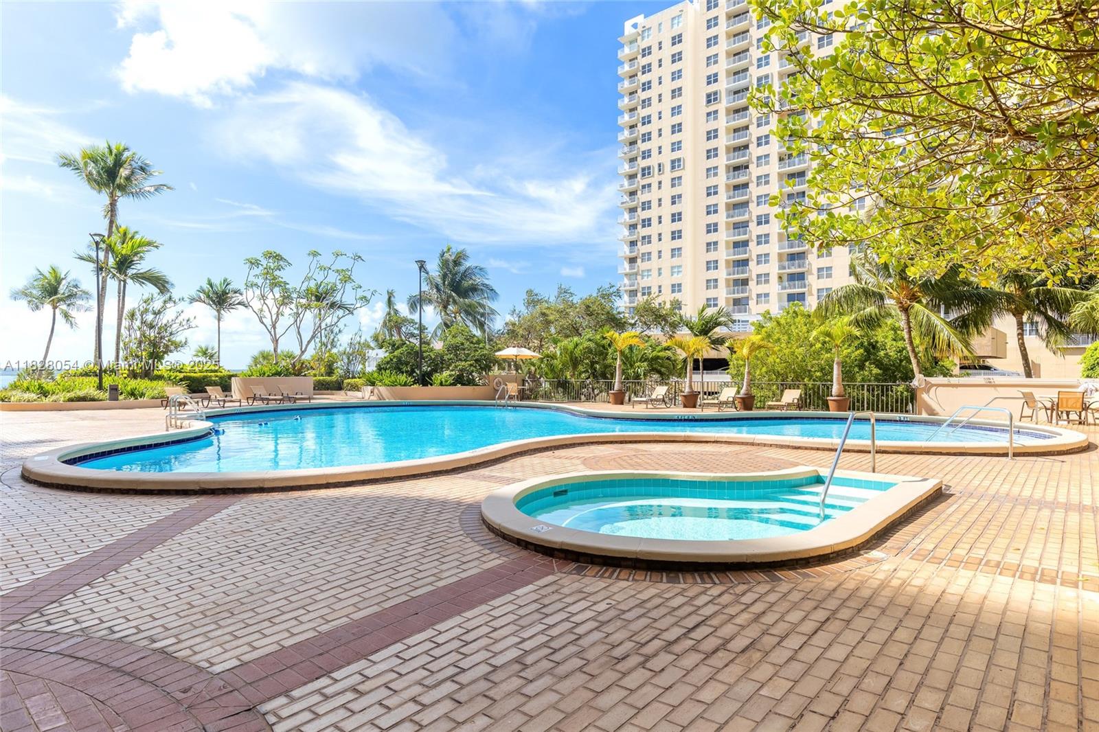 520 Brickell Key Drive, Unit A1817 Miami, FL 33131 - Photo 15 of 20 a view of a swimming pool with an outdoor space and seating area
