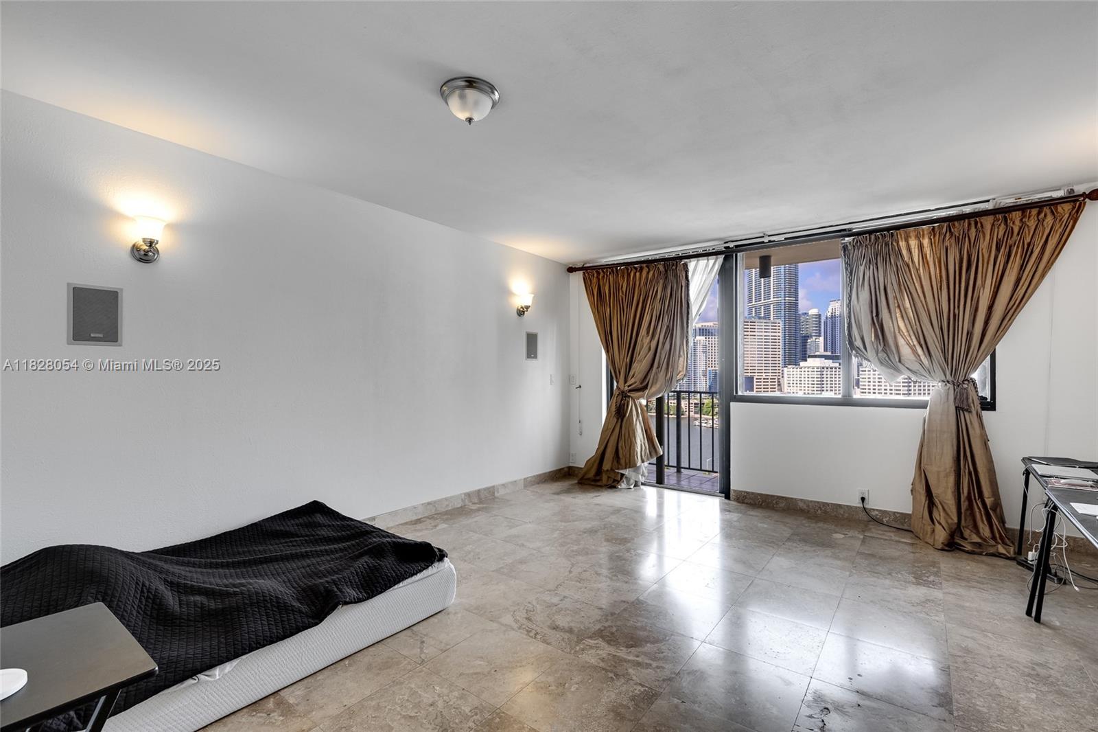 520 Brickell Key Drive, Unit A1817 Miami, FL 33131 - Photo 5 of 20 a view of a livingroom with furniture and a window