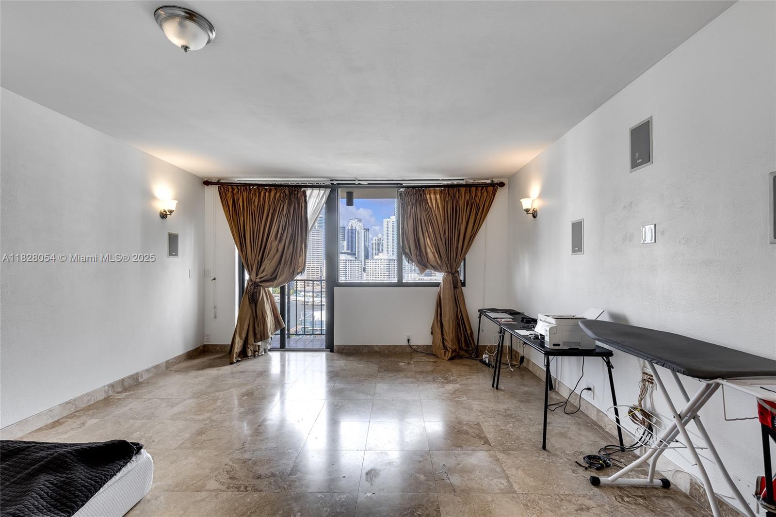520 Brickell Key Drive, Unit A1817 Miami, FL 33131 - Photo 8 of 20 a view of a livingroom with furniture and a window