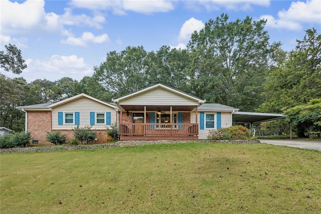 3493 Ridgecrest Drive Powder Springs, GA 30127 - Photo 1 of 1 a front view of a house with a garden