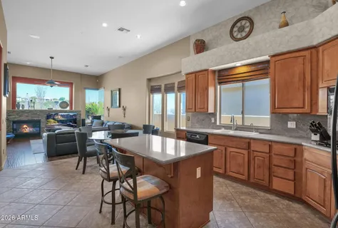a kitchen with center island table and chairs