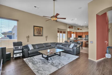 a living room with furniture a rug and a chandelier