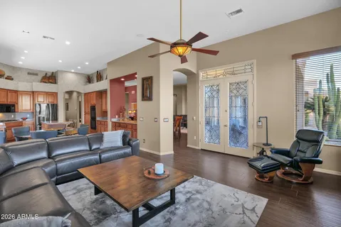 a living room with furniture a rug and a chandelier