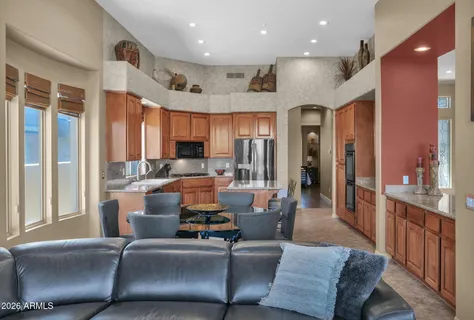 a living room with furniture wooden floor and a large window