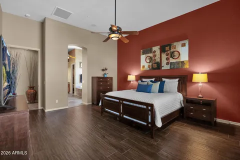 a bedroom with a bed and wooden floor