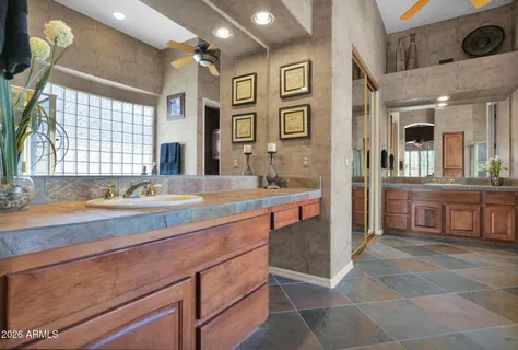 a spacious bathroom with a sink double vanity and a mirror