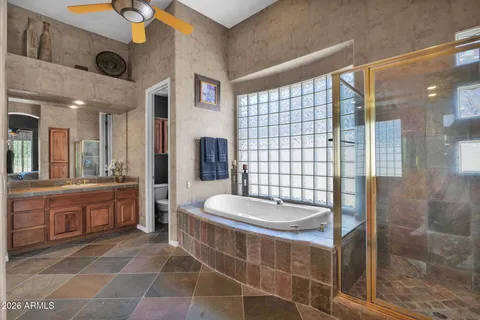 a bathroom with a double vanity sink toilet and shower