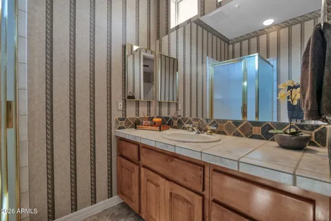 a bathroom with a double vanity sink and a mirror