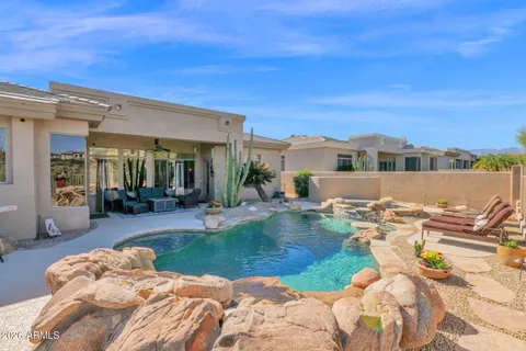a view of a house with swimming pool and furniture