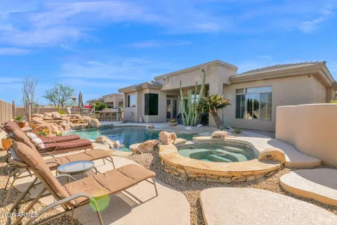 a view of a lake with couches and city view