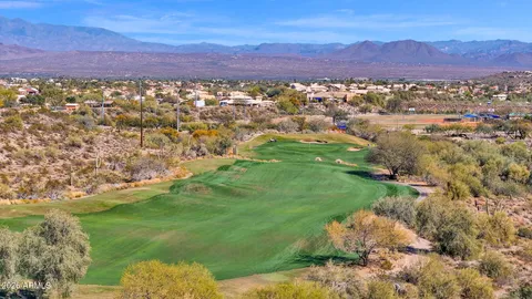 an aerial view of residential houses with outdoor space and ocean view