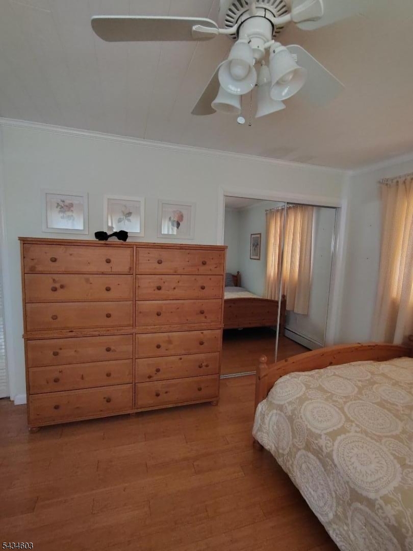 442 River Road North Arlington, NJ 07031 - Photo 8 of 26 a bedroom with a bed and a chandelier