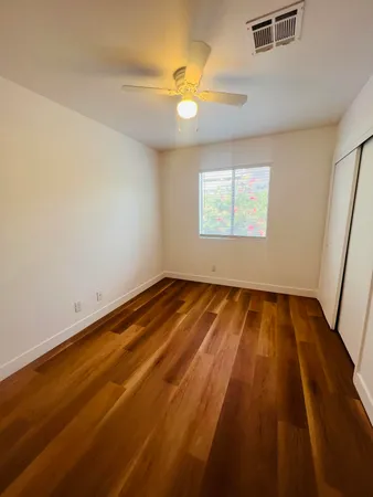 a view of a room with wooden floor and white walls