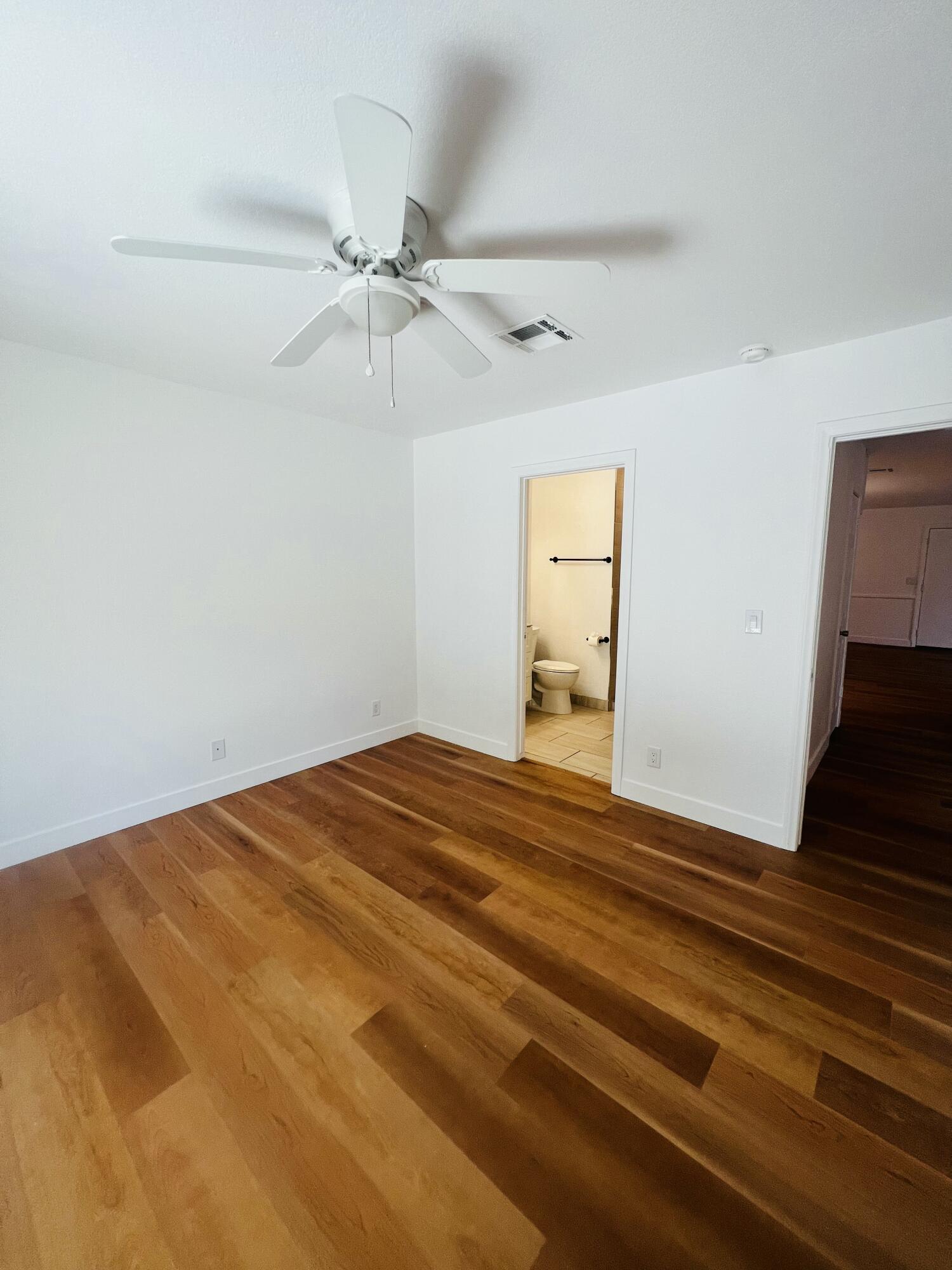 32900 Monte Vista Road Cathedral City, CA 92234 - Photo 15 of 18 a bedroom with a bed and a chandelier