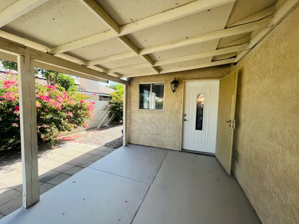 a kitchen with wooden floor and white cabinets