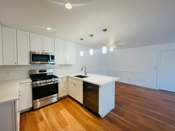 a kitchen with a sink stove and cabinets