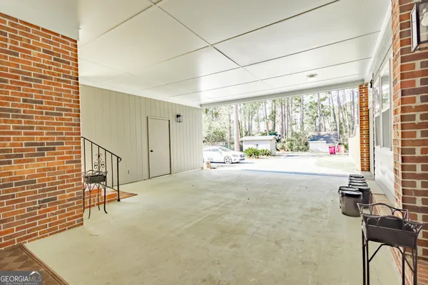 a view of house with wooden floor and flower pot