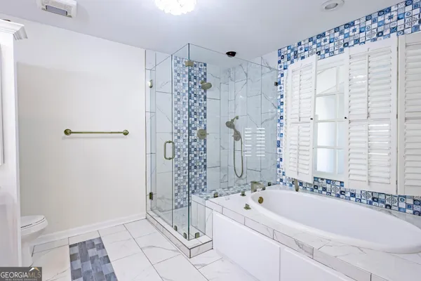 a view of a bathroom from a corridor