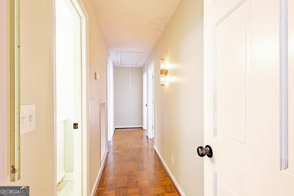 an empty room with wooden floor and a window