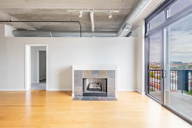 a view of a livingroom with a fireplace and window