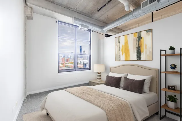 a bedroom with a bed and a window