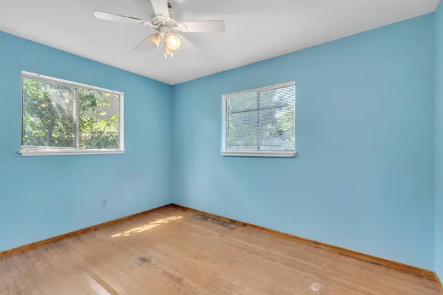 a view of room with window and ceiling fan