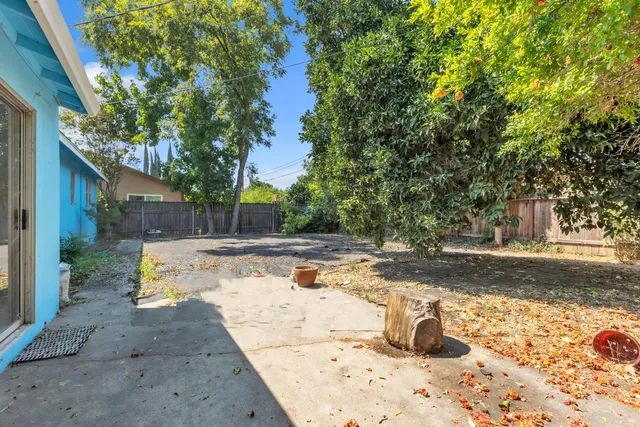 a view of a yard with wooden fence