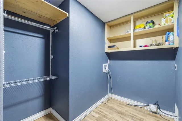 a view of storage and utility room with closet