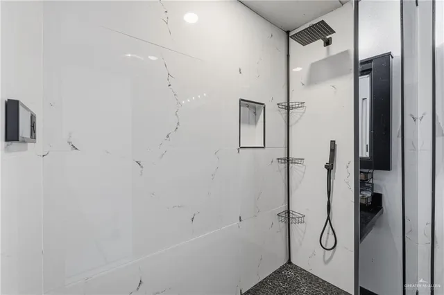 a bathroom with a shower and a glass door