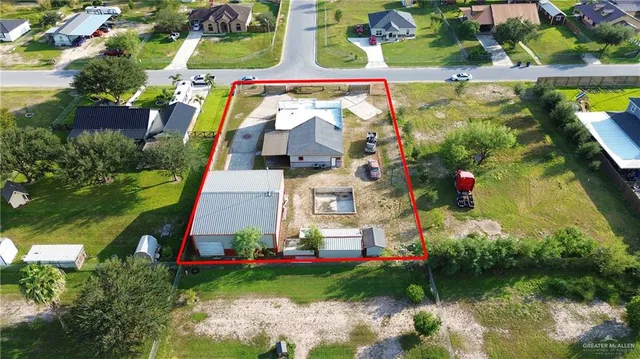 an aerial view of residential houses with outdoor space and swimming pool