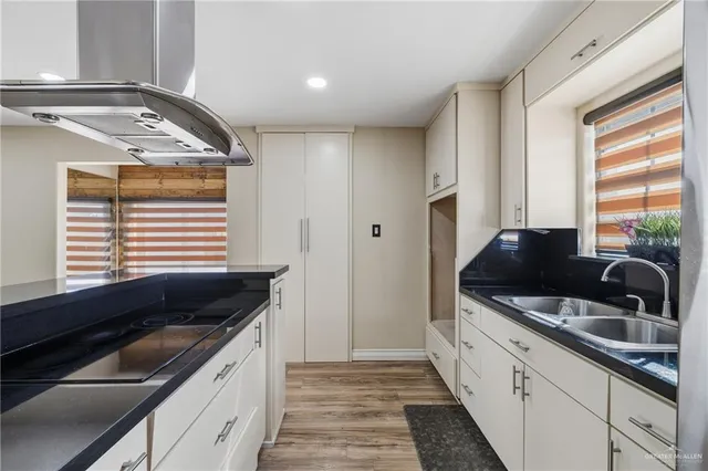 a kitchen with granite countertop a sink and a stove