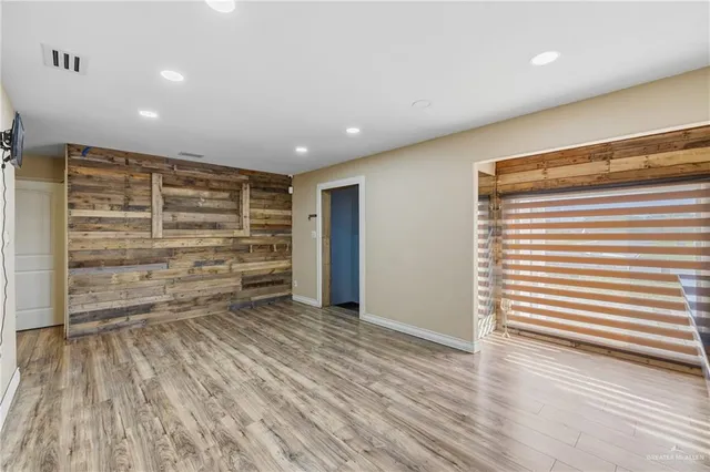 a view of room with wooden floor and a window