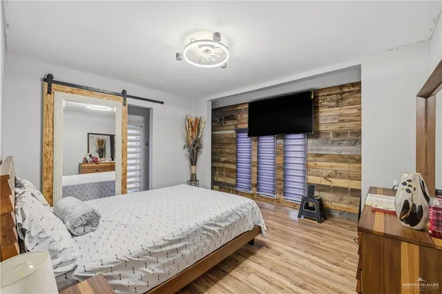 a bedroom with a bed and a flat screen tv