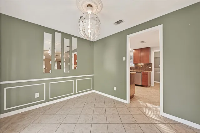 a view of a kitchen with an empty space and a window