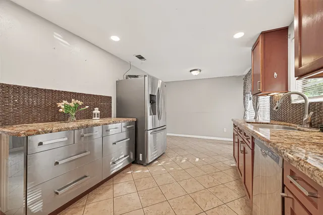a kitchen with a stove a sink and a refrigerator