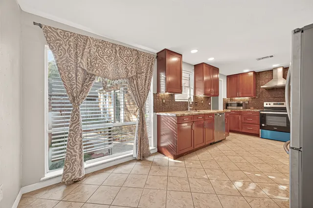 a kitchen with stainless steel appliances a refrigerator and cabinets