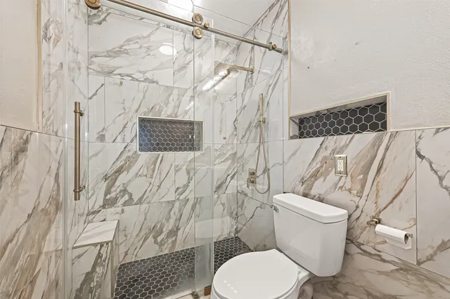 a white toilet sitting next to a shower curtain