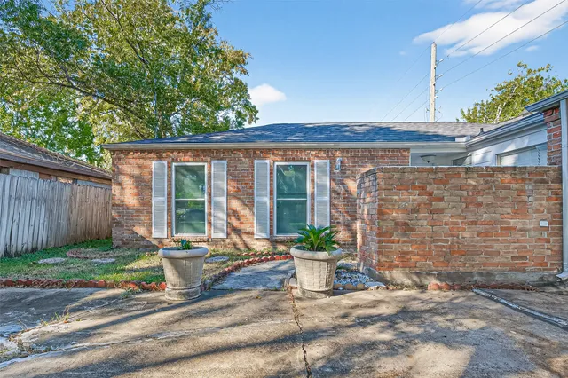 a view of a chair and table in backyard of the house
