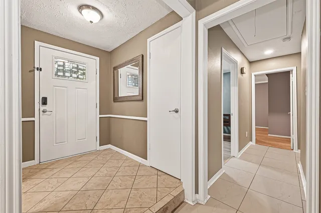 a view of a hallway to rooms