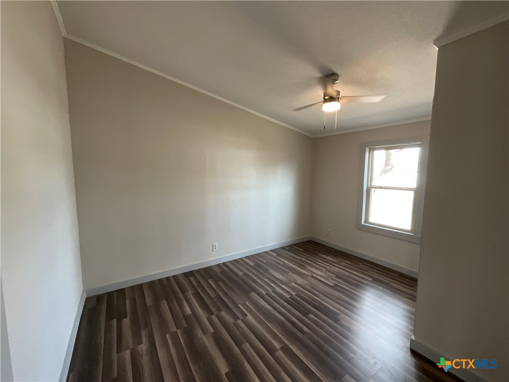 2301 Sumac Lane Cedar Park, TX 78613 - Photo 17 of 26 an empty room with wooden floor chandelier fan and windows