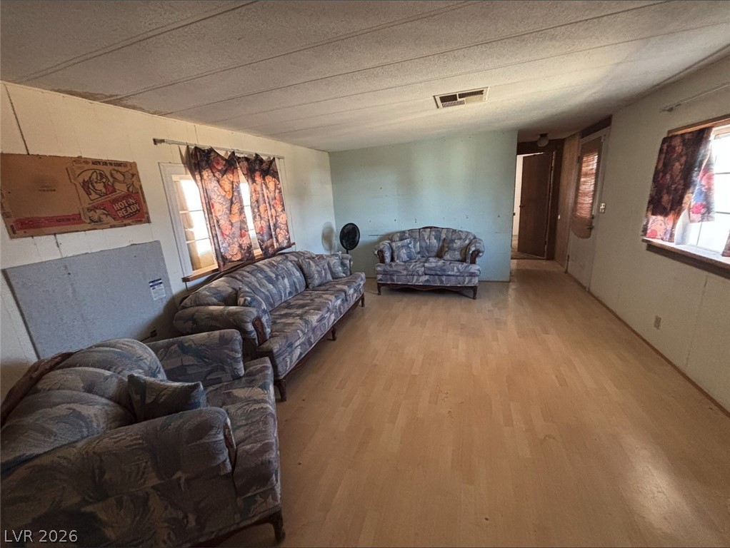 1301 East Manse Road Pahrump, NV 89048 - Photo 10 of 14 A spacious room offers ample potential with its light wood flooring and well-lit windows.