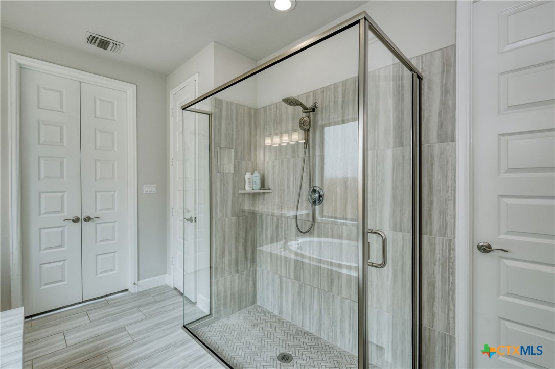 1401 Mulberry Oak Lane Georgetown, TX 78628 - Photo 16 of 30 Bathroom featuring a shower stall and recessed lighting