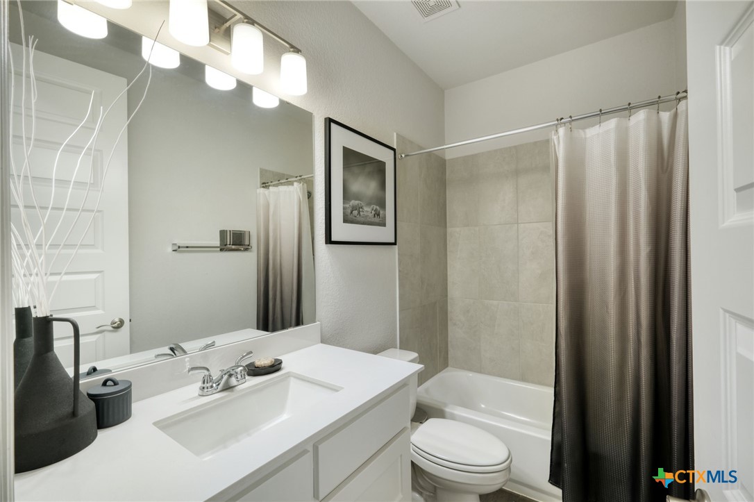 1401 Mulberry Oak Lane Georgetown, TX 78628 - Photo 17 of 29 a bathroom with a sink a toilet and shower